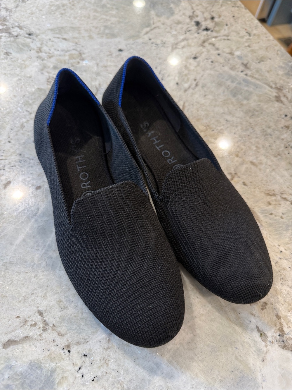 Rothy's Black Slip-On Flats with Blue Trim